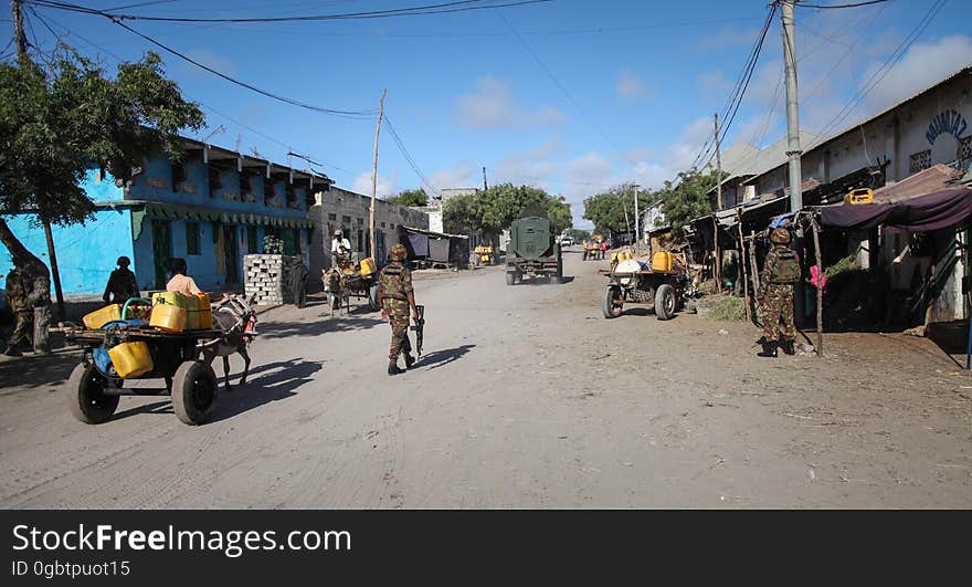 SOMALIA, Kismayo: In a photogaph taken 12 October 2013 and released by the African Union-United Nations Information Support Team 15 October, Kenyan soldiers serving with the African Union Mission in Somalia &#x28;AMISOM&#x29; patrol the streets of the southern Somali port city of Kismayo. October 16 marks two years since the Kenya Defense Force first intervened in Somalia under Operation Linda Nchi - meaning Operation Protect the Country in Kiswahili - following a series of kidnappings and cross-border raids along the Kenya-Somalia border by the Al-Qaeda-affiliated terrorist group Al Shabaab. KDF forces were fully integrated into the African Union mission on 22 February 2012 and saw them capture the strategically and economiclly important port city of Kismayo from Al Shabaab in early October 2012 after a sustained 6-month advance across southern Somalia. AU/UN IST PHOTO / RAMADAN MOHAMED HASSAN. SOMALIA, Kismayo: In a photogaph taken 12 October 2013 and released by the African Union-United Nations Information Support Team 15 October, Kenyan soldiers serving with the African Union Mission in Somalia &#x28;AMISOM&#x29; patrol the streets of the southern Somali port city of Kismayo. October 16 marks two years since the Kenya Defense Force first intervened in Somalia under Operation Linda Nchi - meaning Operation Protect the Country in Kiswahili - following a series of kidnappings and cross-border raids along the Kenya-Somalia border by the Al-Qaeda-affiliated terrorist group Al Shabaab. KDF forces were fully integrated into the African Union mission on 22 February 2012 and saw them capture the strategically and economiclly important port city of Kismayo from Al Shabaab in early October 2012 after a sustained 6-month advance across southern Somalia. AU/UN IST PHOTO / RAMADAN MOHAMED HASSAN.