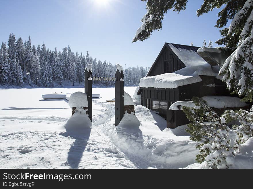 Winter snow covers the lake and boathouse. Winter snow covers the lake and boathouse.