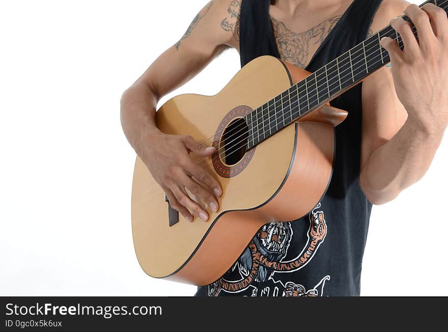 Person in Black Tank Top Playing Acoustic Guitar