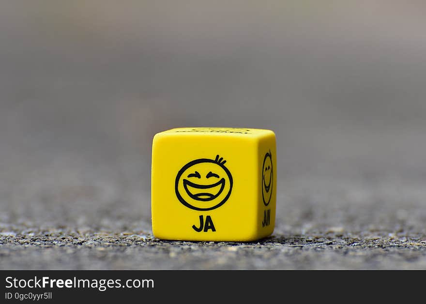 An yellow cube with different emotions on a street. An yellow cube with different emotions on a street.