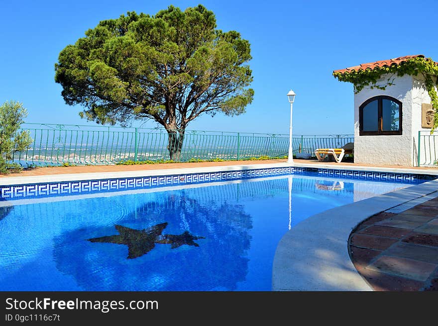 A blue swimming pool in a tropical resort. A blue swimming pool in a tropical resort.