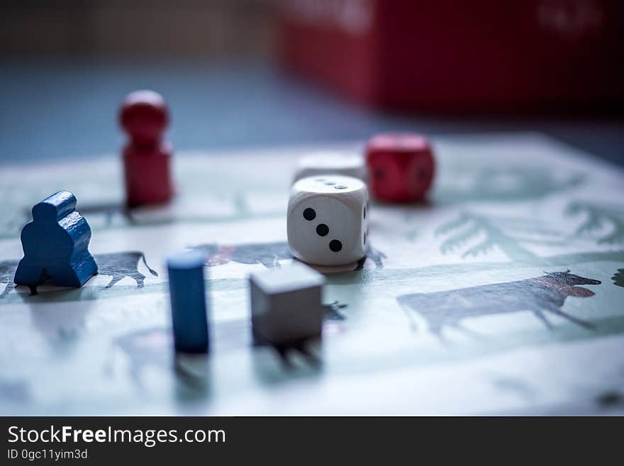 A board game with dice and pieces on a table.