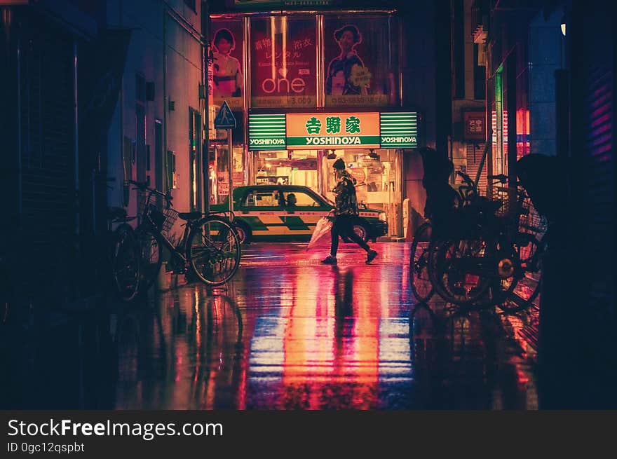 Side View of Woman in Illuminated City at Night