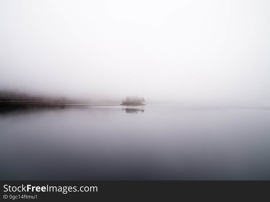 Morning dawns over foggy waters.