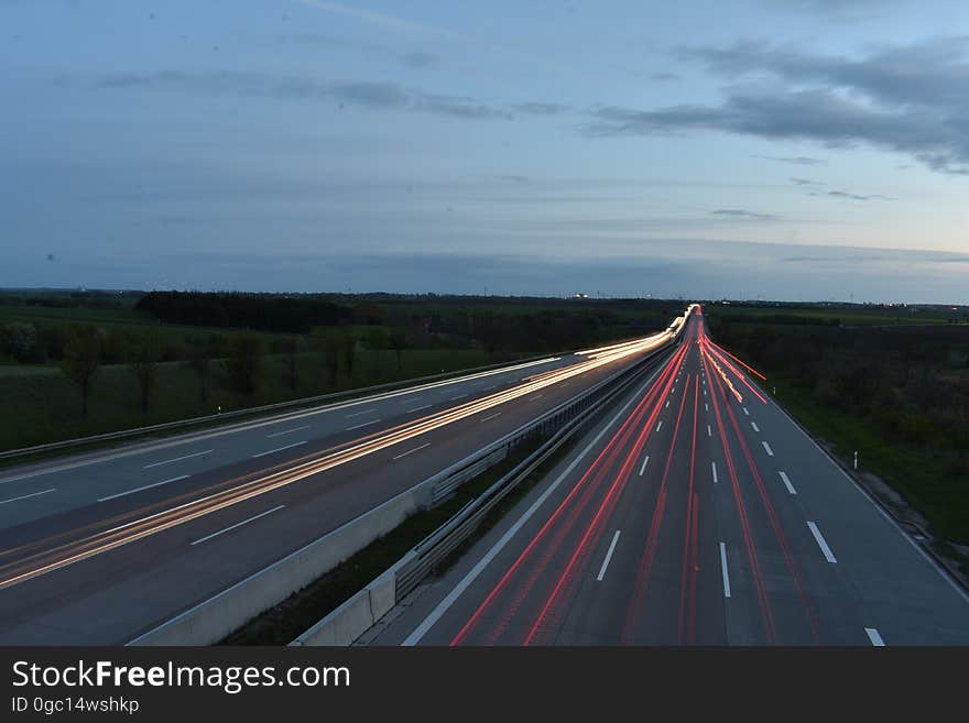 Blur of traffic headlights and taillights on rural highway at dusk. Blur of traffic headlights and taillights on rural highway at dusk.