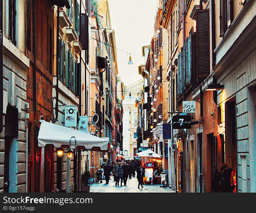 People on busy downtown street or alleyway with shops in daylight. People on busy downtown street or alleyway with shops in daylight.