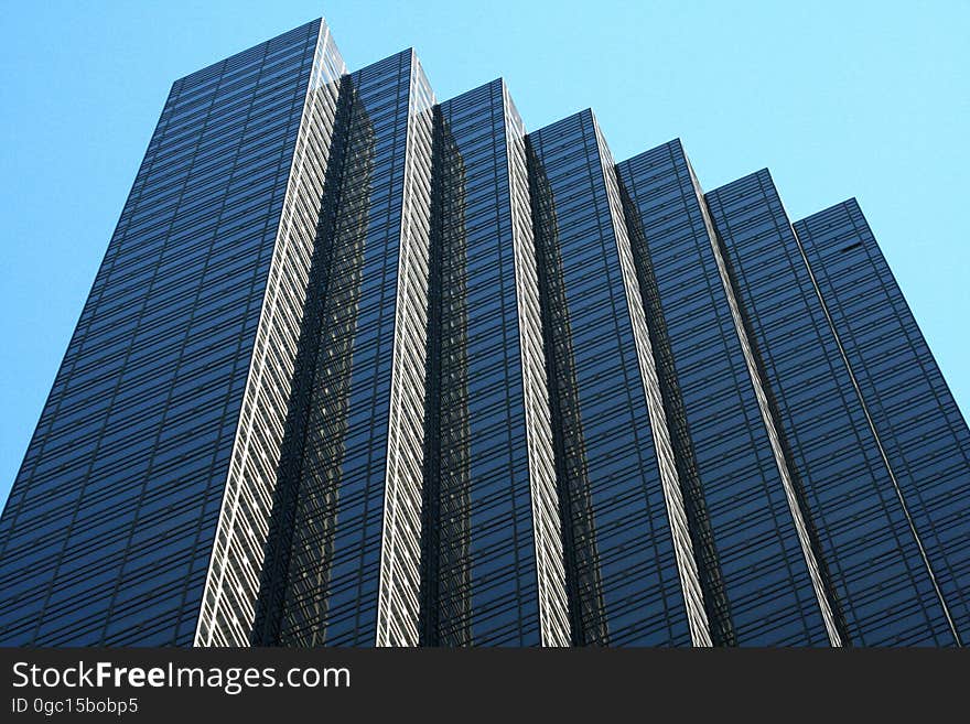 Exterior of modern angular high rise building against blue skies. Exterior of modern angular high rise building against blue skies.