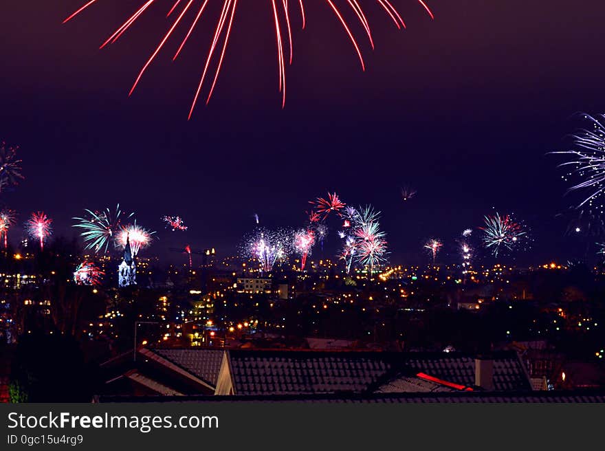 Fireworks illuminating city skyline at night. Fireworks illuminating city skyline at night.