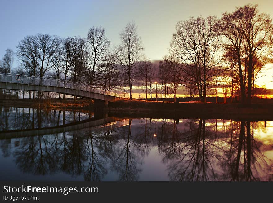 Bridge over river in countryside landscape at sunset. Bridge over river in countryside landscape at sunset.