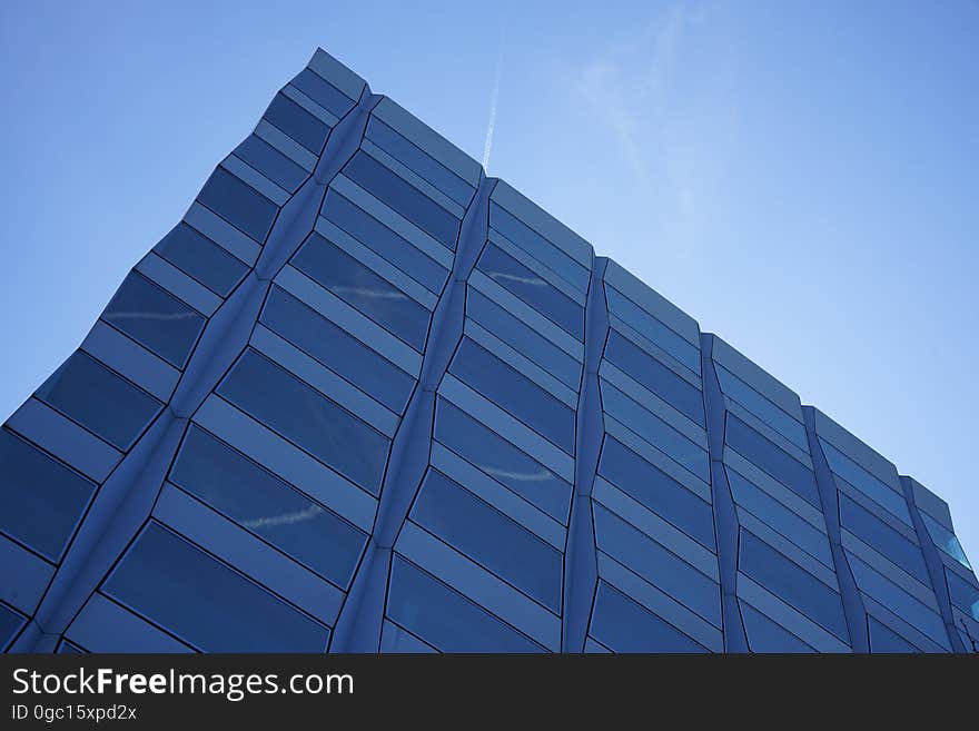 Angular corner of modern architecture against blue skies on sunny day. Angular corner of modern architecture against blue skies on sunny day.