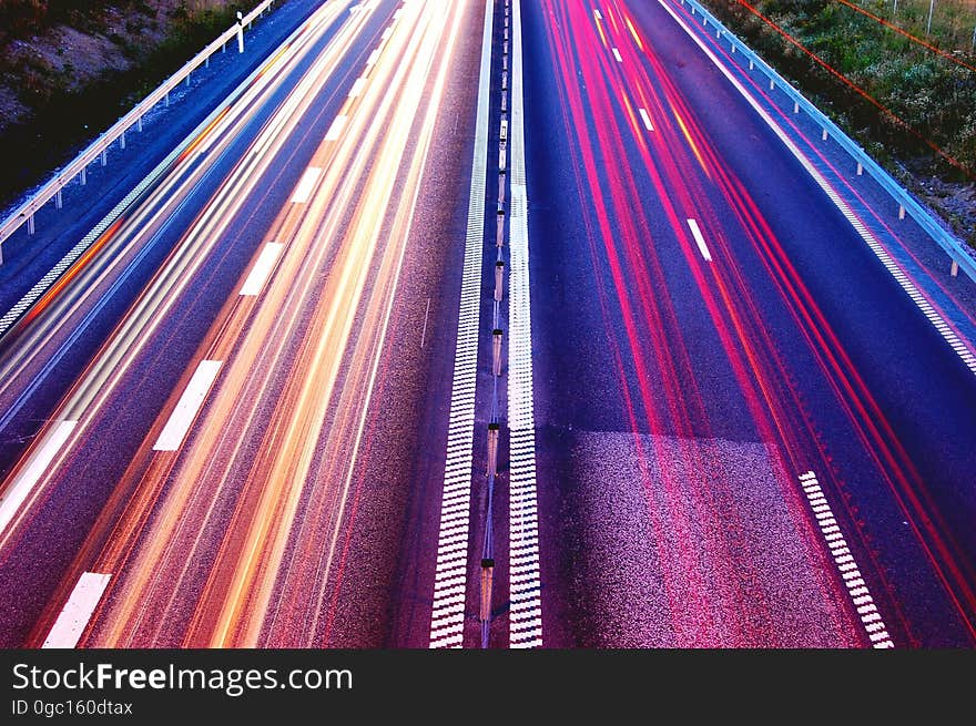 Blur of headlights and taillights on divided highway from above. Blur of headlights and taillights on divided highway from above.