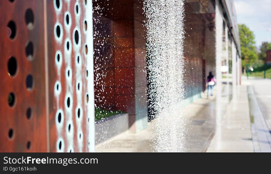 Close up of water falling in fountain in city park on sunny day. Close up of water falling in fountain in city park on sunny day.