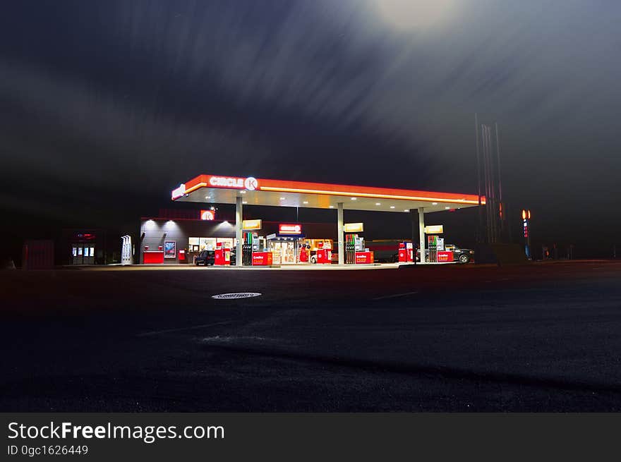 Exterior of modern gas station illuminated at night.