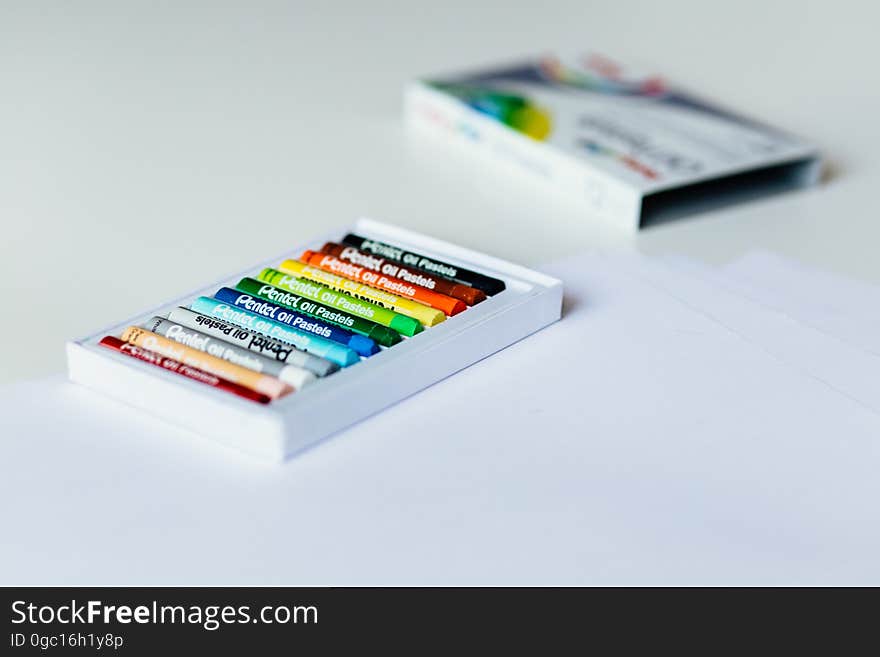 A box of color crayons in a box on white background.