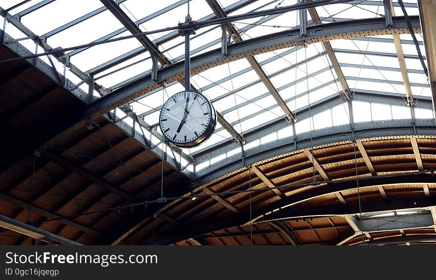 A clock hanging from the ceiling of a transit terminal. A clock hanging from the ceiling of a transit terminal.