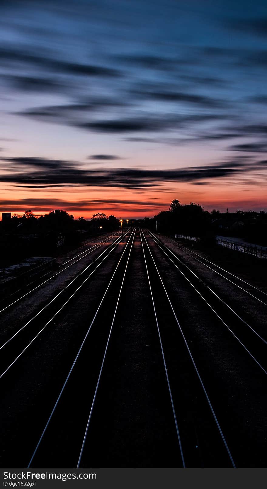 Railroad tracks heading off to the distance in the sunset. Railroad tracks heading off to the distance in the sunset.