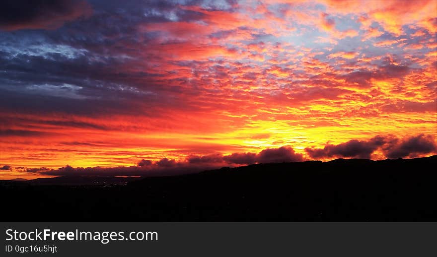 Sunrise through clouds in orange skies. Sunrise through clouds in orange skies.