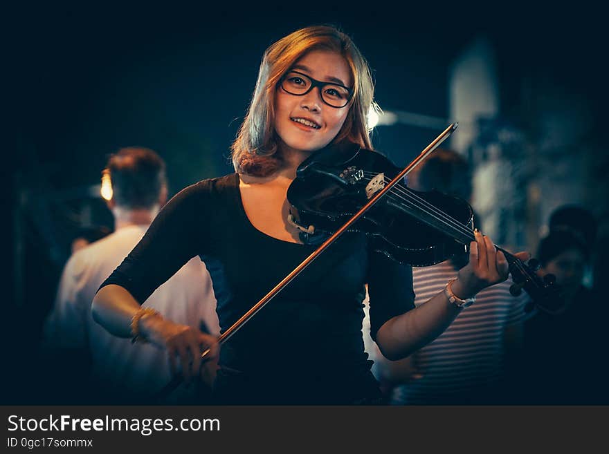 Portrait of smiling woman playing violin. Portrait of smiling woman playing violin.