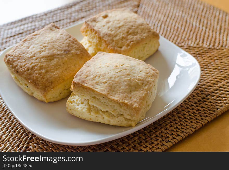 A plate of bread or other baked goods on a table.