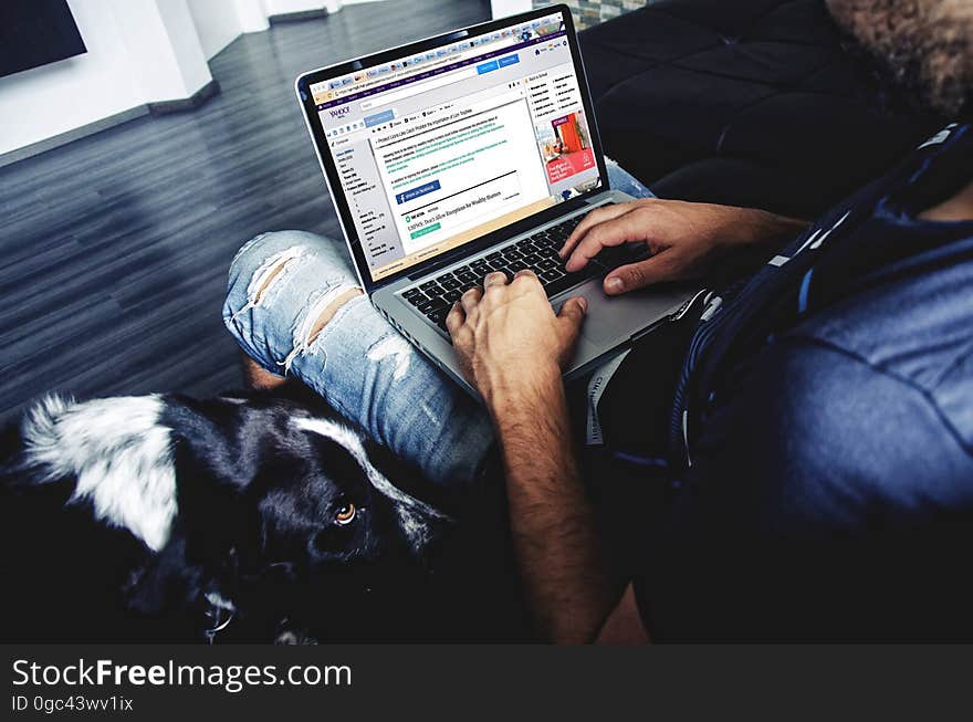 View of man using laptop computer.