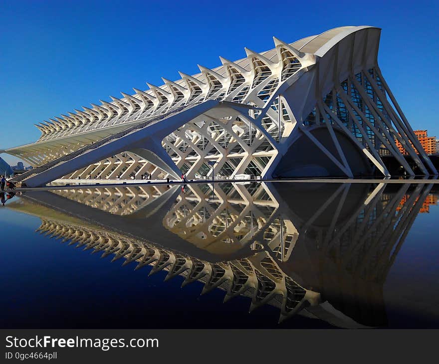 Exterior of modern architecture reflecting in waterfront.