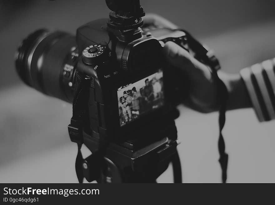 A camera on a tripod shooting video in black and white. A camera on a tripod shooting video in black and white.