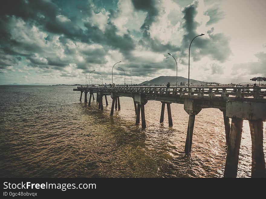 A long jetty extending into the distance on the coast of the sea. A long jetty extending into the distance on the coast of the sea.