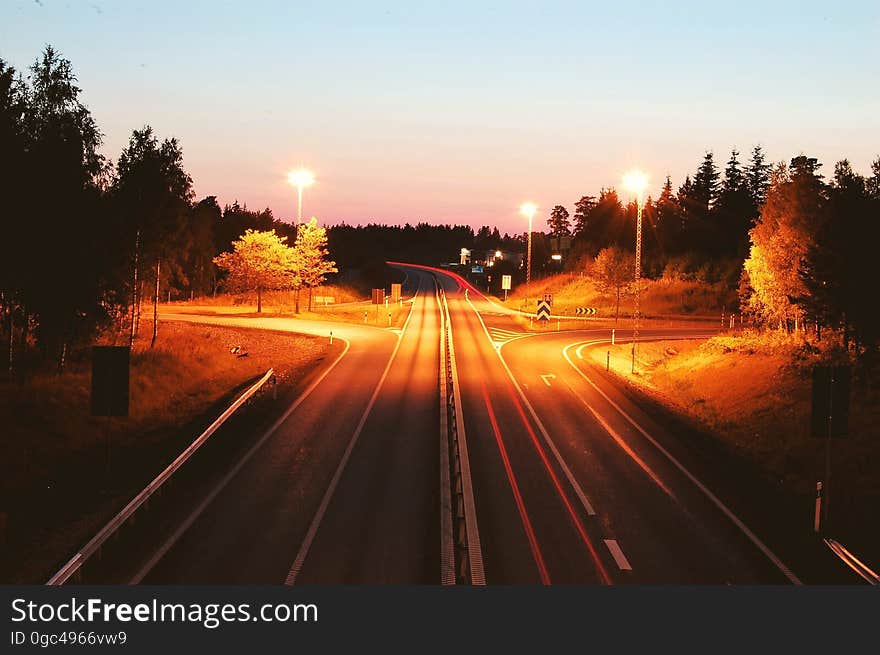 A long exposure of a highway with light trails of the traffic. A long exposure of a highway with light trails of the traffic.