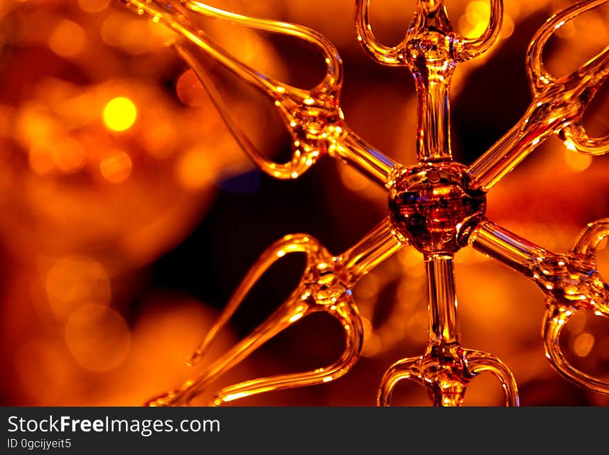 Close up of glass ornament with orange light background. Close up of glass ornament with orange light background.