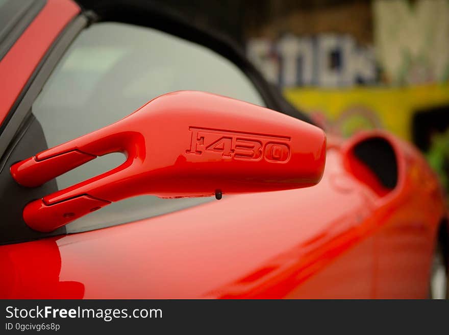 The side mirror of a red Ferrari. The side mirror of a red Ferrari.