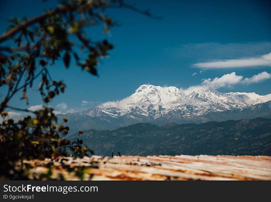 A snowy mountain peak in the distance with blue skies. A snowy mountain peak in the distance with blue skies.