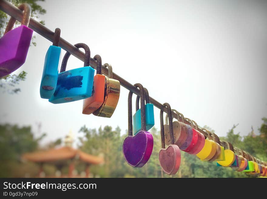 A love lock or love padlock is a padlock which sweethearts lock to a bridge, fence, gate, or similar public fixture to symbolize their love. Typically the sweethearts&#x27; names or initials are inscribed on the padlock, and its key is thrown away to symbolize unbreakable love. Since the 2000s, love locks have proliferated at an increasing number of locations worldwide. They are now mostly treated by municipal authorities as litter or vandalism, and there is some cost to their removal. However, there are authorities who embrace them, and who use them as fundraising projects or tourism attractions. A love lock or love padlock is a padlock which sweethearts lock to a bridge, fence, gate, or similar public fixture to symbolize their love. Typically the sweethearts&#x27; names or initials are inscribed on the padlock, and its key is thrown away to symbolize unbreakable love. Since the 2000s, love locks have proliferated at an increasing number of locations worldwide. They are now mostly treated by municipal authorities as litter or vandalism, and there is some cost to their removal. However, there are authorities who embrace them, and who use them as fundraising projects or tourism attractions.