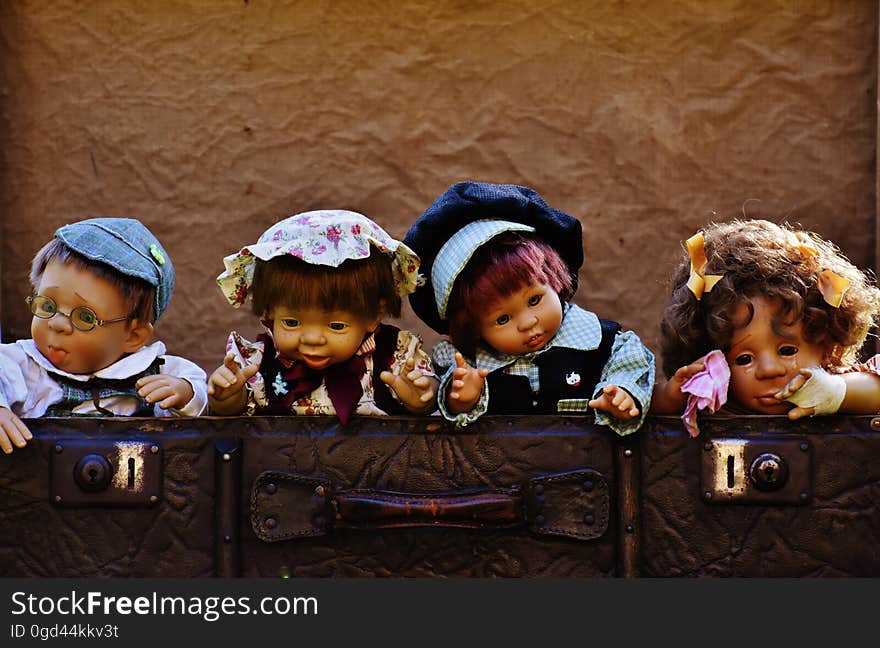 An antique suitcase with dolls inside. An antique suitcase with dolls inside.