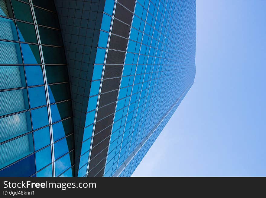 A skyscraper with glass window facade against the blue skies. A skyscraper with glass window facade against the blue skies.