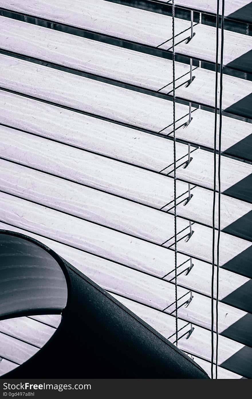 A view of window blinds in the window seen from the inside.