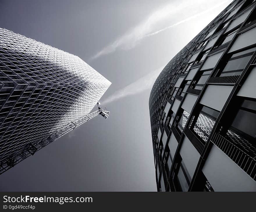 A pair of modern skyscrapers seen from the street.