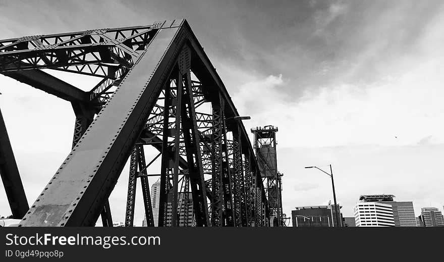 A steel bridge in the city in black and white.