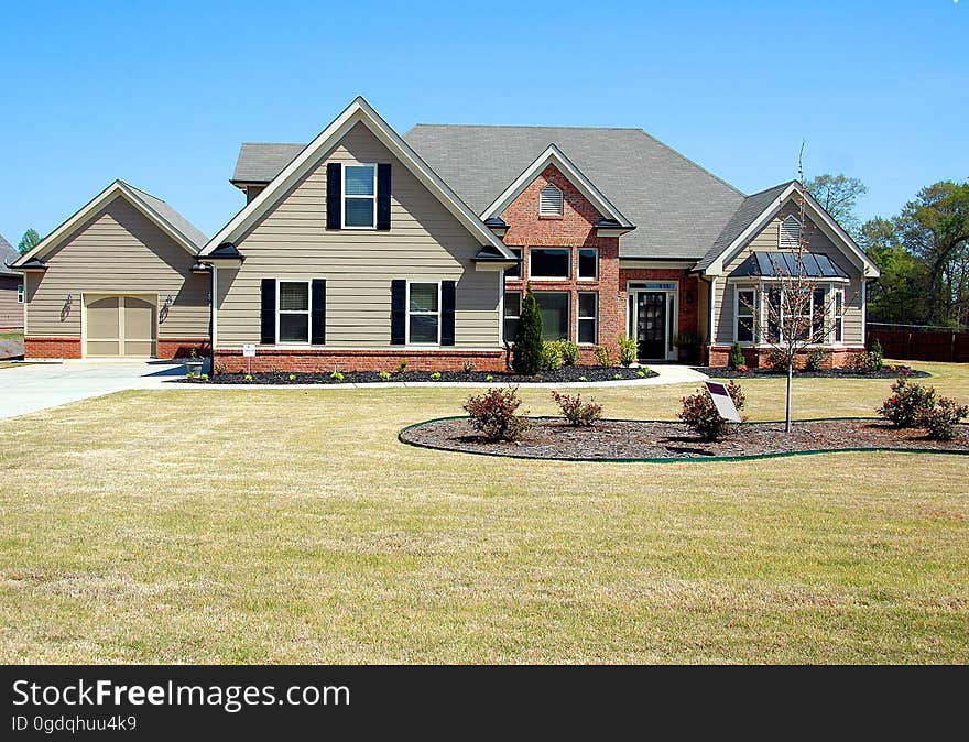 A modern home with a large yard.