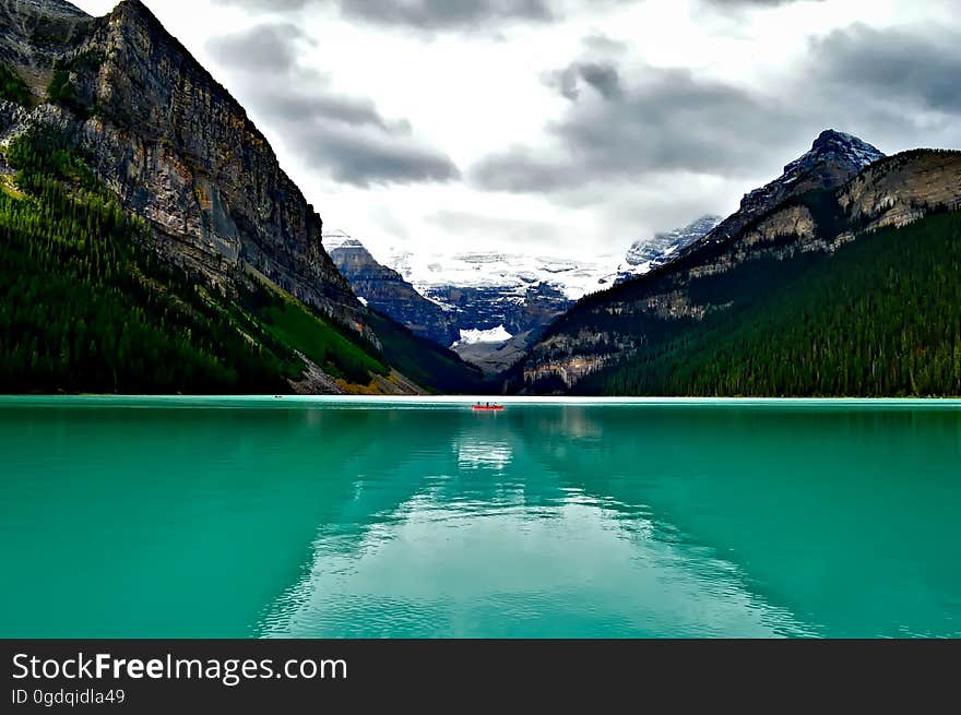 A beautiful green lake framed by mountains.