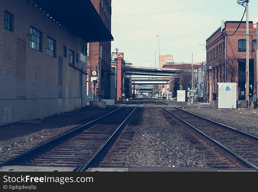 Empty railroad tracks in a city.