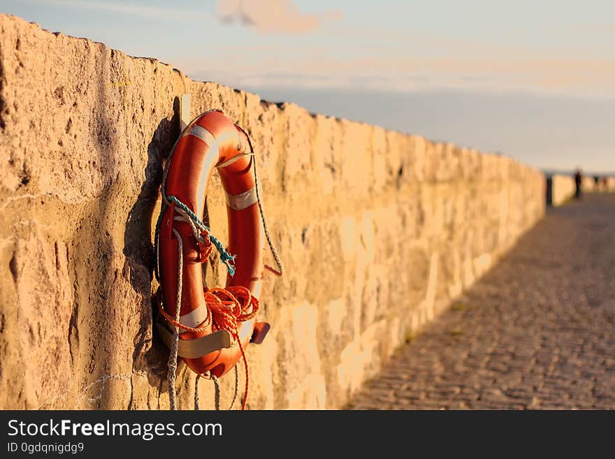 Life buoy hanging on a wall at a beach.