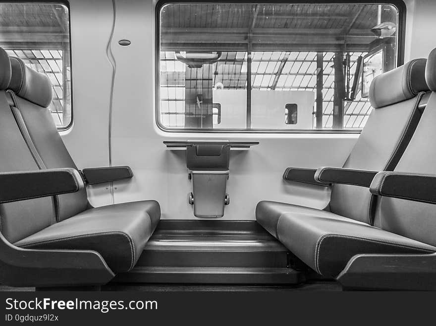 Standard seating with arm rests and head rests in a passenger train stationary in a station. Standard seating with arm rests and head rests in a passenger train stationary in a station.