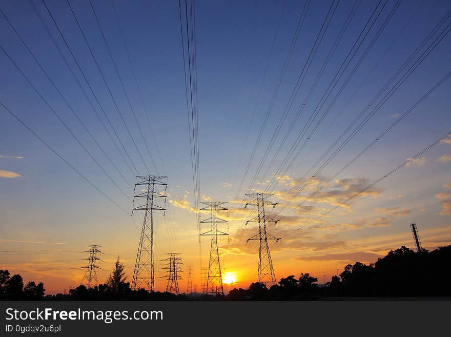 Silhouette of high voltage transmission towers.