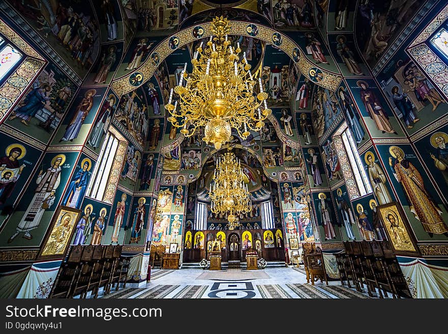 Gold Chandelier and Green Blue and White Wall