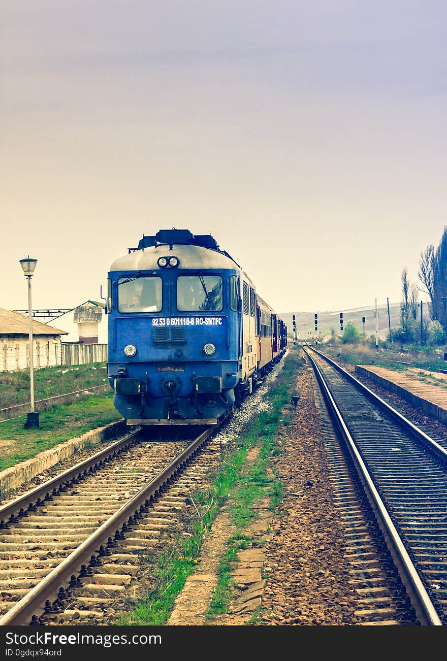 Front view of a moving train traveling on a track beside another vacant track. Front view of a moving train traveling on a track beside another vacant track.