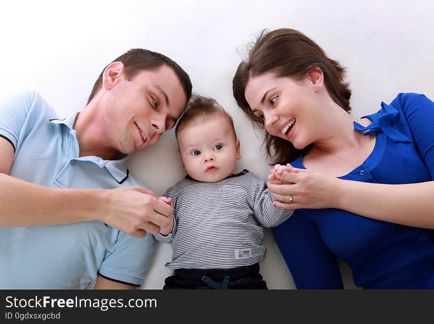 Man Beside Baby and Woman