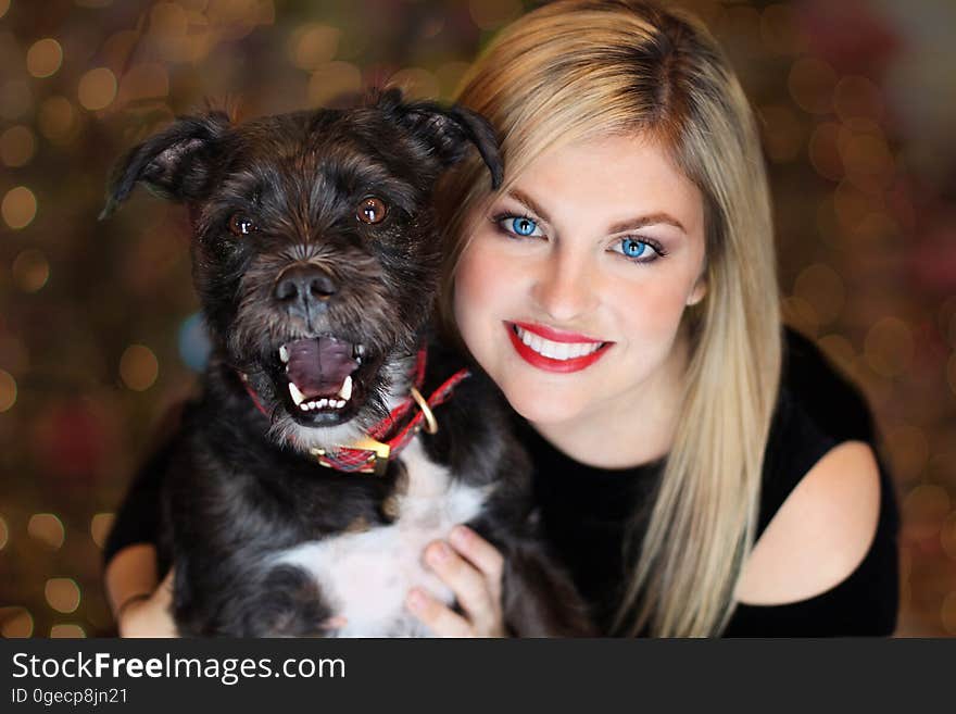 A woman holding a dog close to herself. A woman holding a dog close to herself.