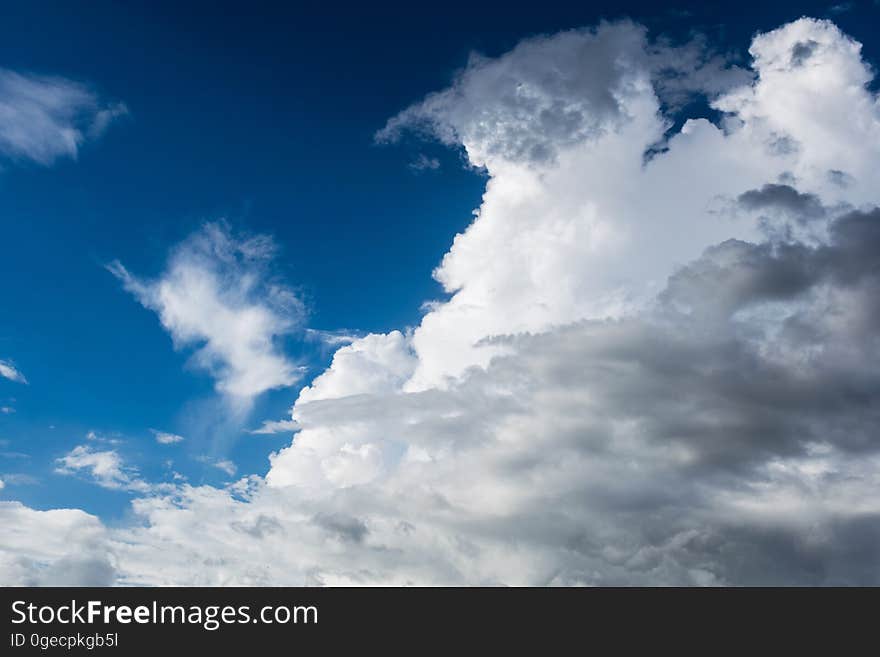 Cumulus clouds on blue sky background.