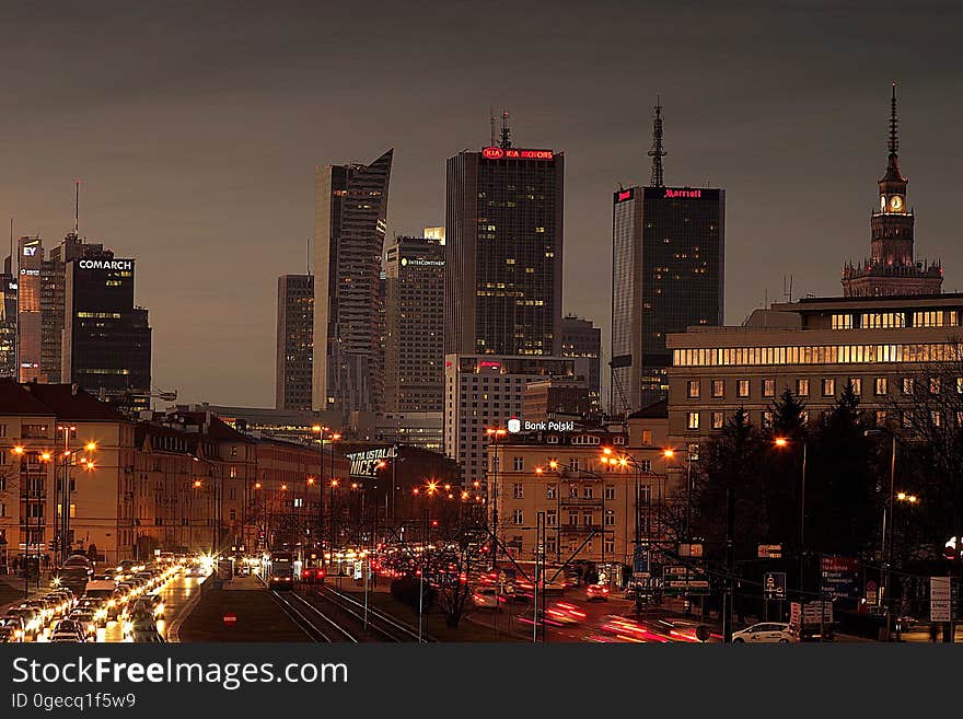 A modern cityscape at night with heavy traffic.