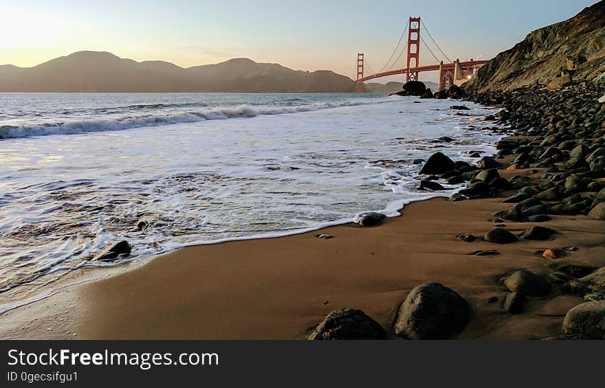 Waves breaking on beach with Golden Gate bridge in background, San Francisco, California, USA. Waves breaking on beach with Golden Gate bridge in background, San Francisco, California, USA.